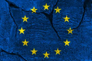 European Union flag on cracked stone wall background<br>EU, kriza, rat