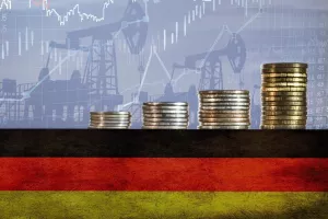Coins on top of the flag of Germany on the background of oil rigs and charts. Concept - increase in the cost of gasoline, diesel, energy in Germany. Increase in the selling price of hydrocarbons.<br>njemačka, inflacija, rast cijena, tro&scaron;kovi, porast tro&scaron;kova, industrija, proizvodnja