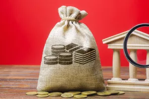 Money bag and government building. Business and finance concept. Deposit, loan and investment in to the bank. Credit. Help from the state. Subsidies and Benefits. Budget. Copy space