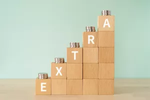 Wooden blocks with "EXTRA" text of concept and coins.