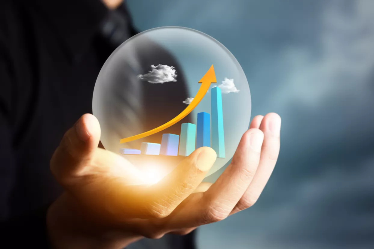 businessman holding increasing graph in crystal ball