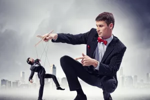 Image of young businessman puppeteer. Leadership concept