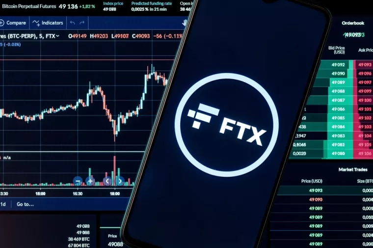 Kazan, Russia - Oct 28, 2021FTX is a cryptocurrency exchange. A smartphone with the FTX logo on the background of the live trading webpage. FTX dashboard.