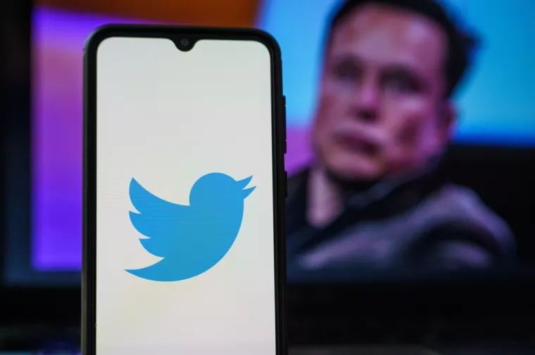 Kaunas, Lithuania 2022 April 5Twitter logo on smartphone and Elon Musk in the background. Elon Musk joins Twitter board