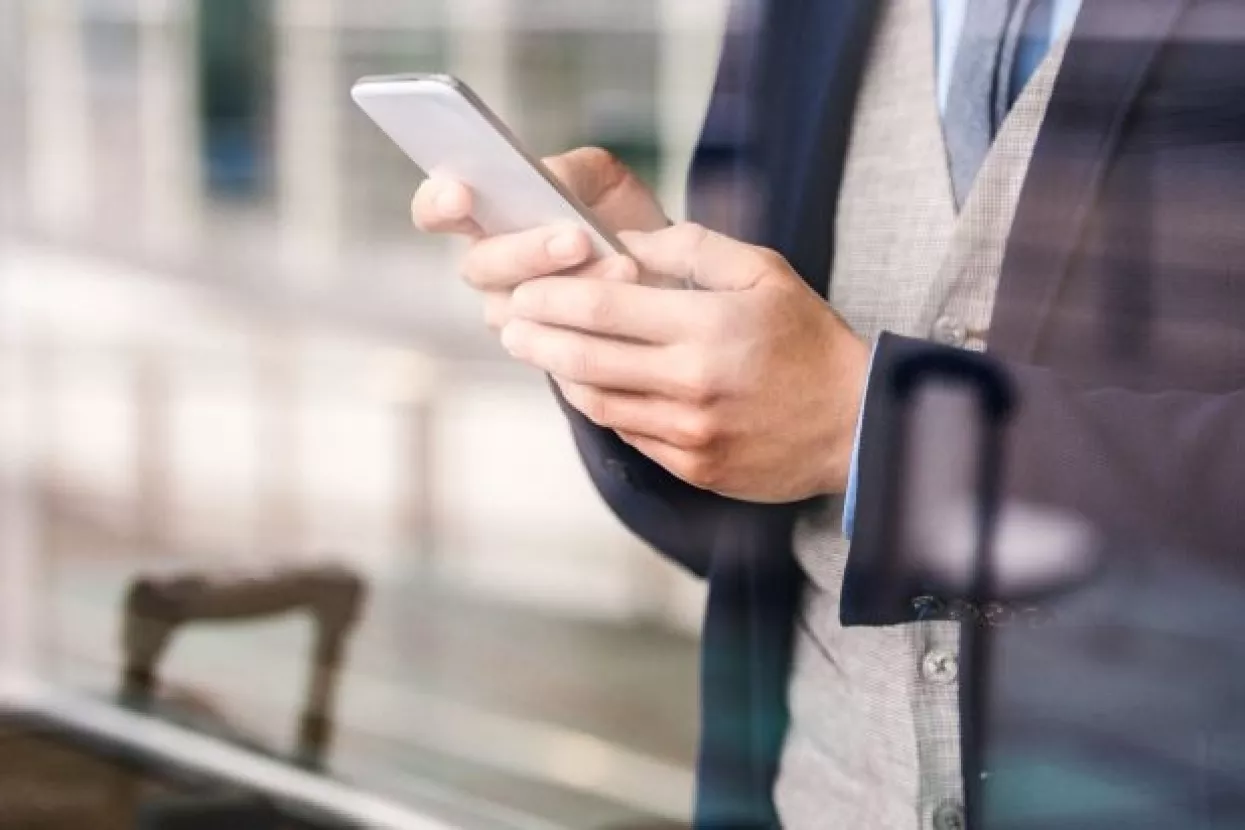 Double exposure of a handsome young man with smart phone