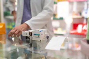 Medications stacked on a pharmacy counter, ready to be sold. Represents a typical scene in the daily routine of a pharmacyljekarni&scaron;tvo, farmacija, ljekarne, ljekarnici