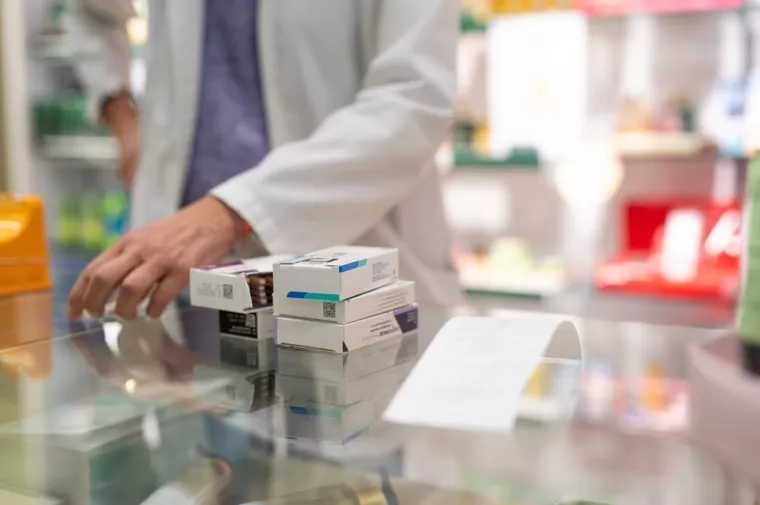 Medications stacked on a pharmacy counter, ready to be sold. Represents a typical scene in the daily routine of a pharmacyljekarni&scaron;tvo, farmacija, ljekarne, ljekarnici