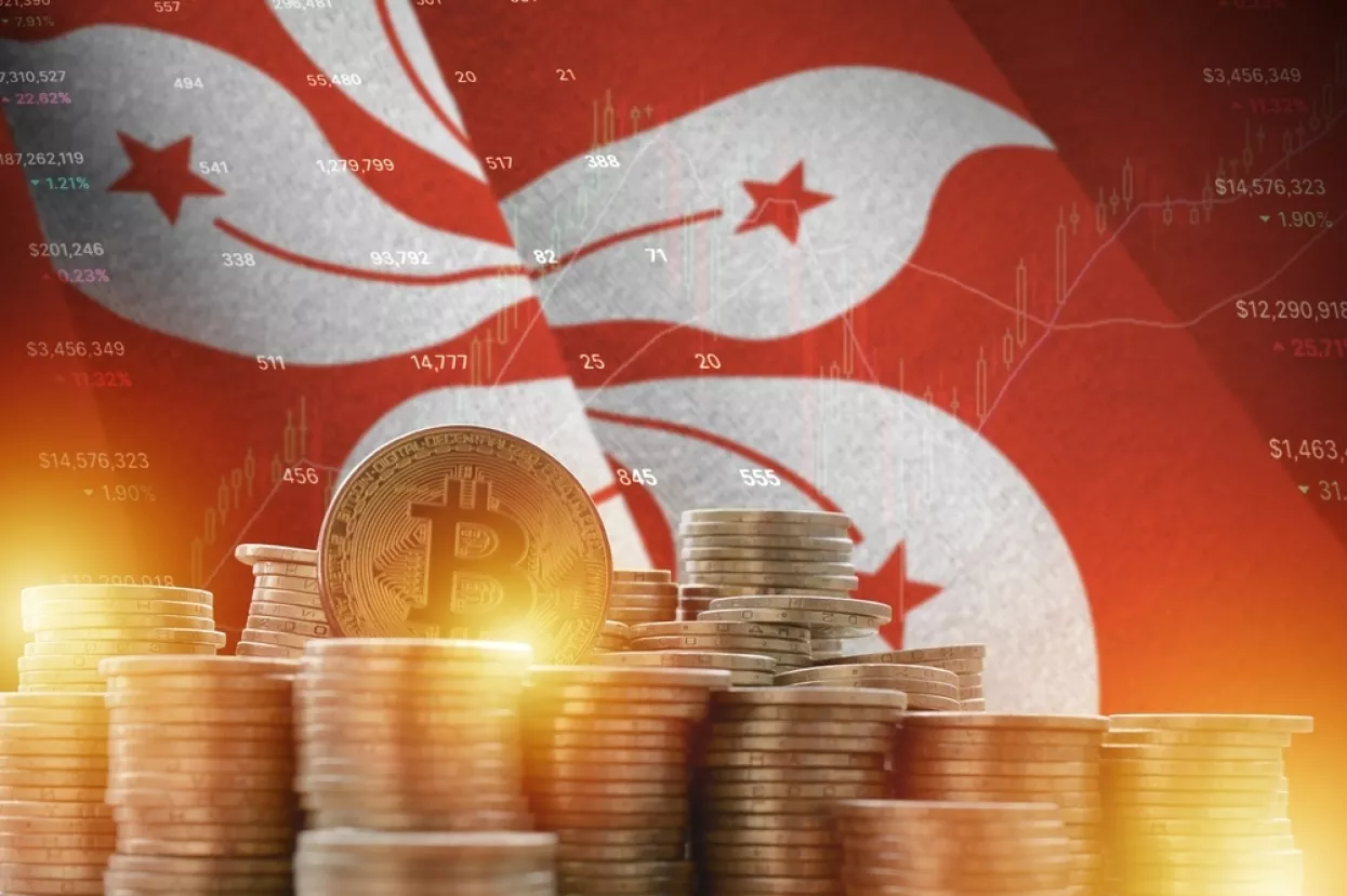 Hong kong flag and big amount of golden bitcoin coins and trading platform chart. Crypto currency concept, kriptovalute