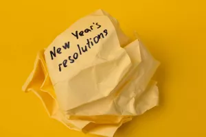 Crumpled paper with New Year's resolutions. The concept of failure at the beginning of a new life.