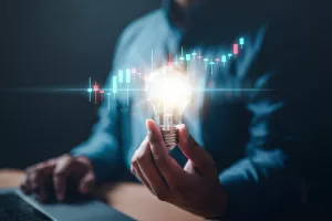 chart, graph, invention, bulb, invest, leadership, marketing, solution, strategy, glowing. A person is holding a light bulb. Concept of innovation and creativity with new ideas and inventions.