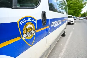 Car of police forces in Croatia. Emblem and name of Croatian police. Police van on the street.