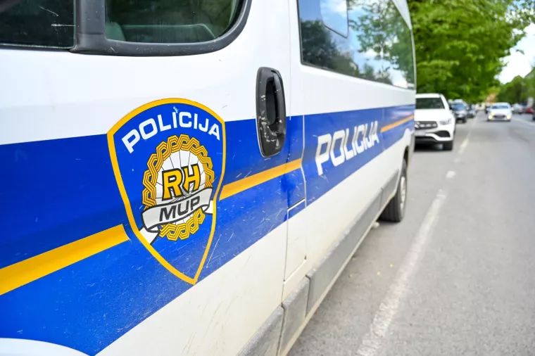 Car of police forces in Croatia. Emblem and name of Croatian police. Police van on the street.