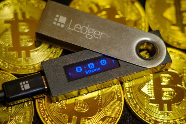 Moscow, Russia - September 8, 2017Cold crypto wallet Ledger Nano S lying on golden bitcoin coins