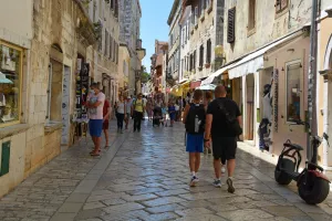 Porec, Croatia- July 10th 2021. A street busy with shops and tourists in the historic medieval coastal town of Porec in Istria, CroatiaPoreč, turizam Hrvatska, Dekumanova