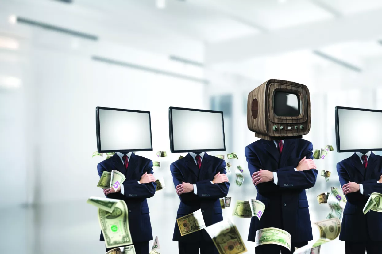 Businessmen in suits with old TV instead of their heads keeping arms crossed while standing in a row and one at the head with TV inside office building.